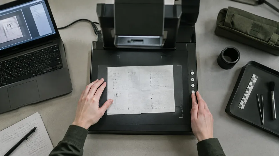 Digital evidence specialist preparing a neutral technical explanation at a document camera station.