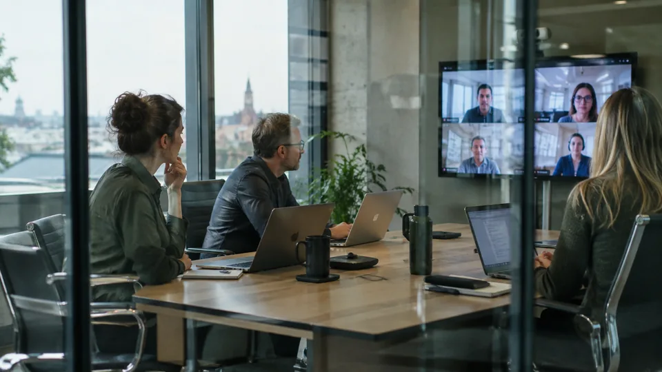 Enterprise coordinators reviewing an incident across regional offices during a video conference.